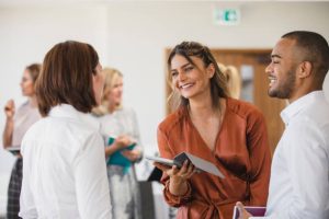 Young businesswoman smiling and listening, networking, collaboration, business conference